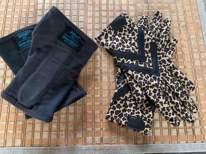 Pair of black IMAK Smart Gloves and pair of leopard print driving gloves side by side